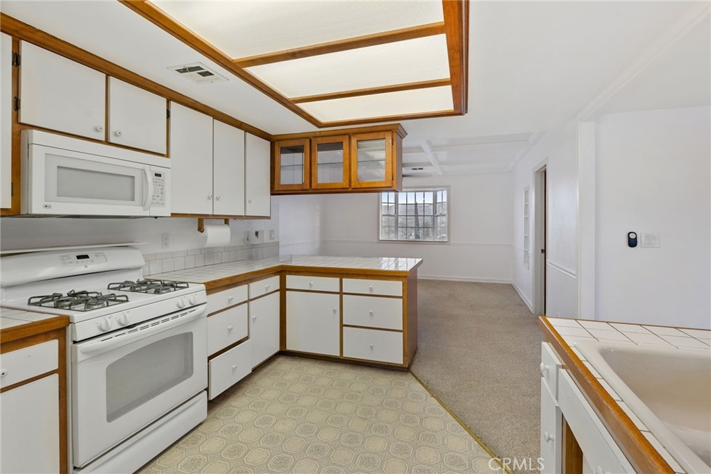 57622 Sierra Way Yucca Valley, CA 92284 - Photo 57 of 75 a kitchen with granite countertop a sink stainless steel appliances and cabinets