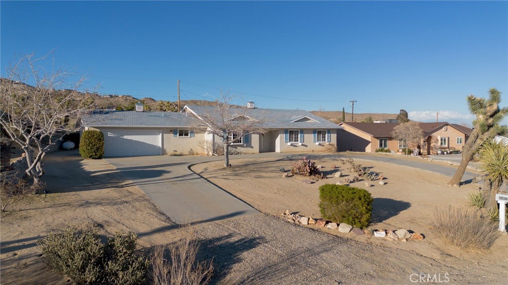 57622 Sierra Way Yucca Valley, CA 92284 - Photo 65 of 75 a front view of a house with a yard