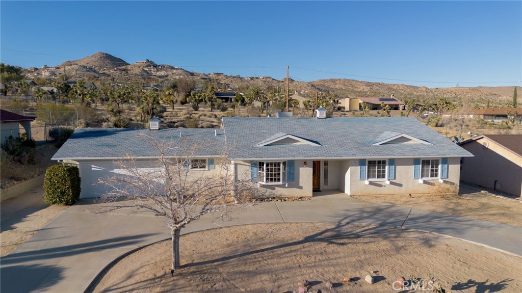 57622 Sierra Way Yucca Valley, CA 92284 - Photo 68 of 75 a view of a white house with a mountain view