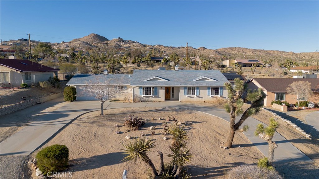 57622 Sierra Way Yucca Valley, CA 92284 - Photo 70 of 75 a front view of a house with a yard