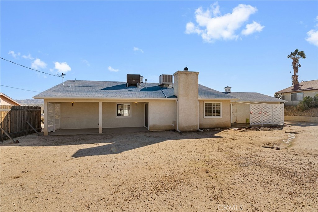 57622 Sierra Way Yucca Valley, CA 92284 - Photo 8 of 75 a front view of a house with a yard