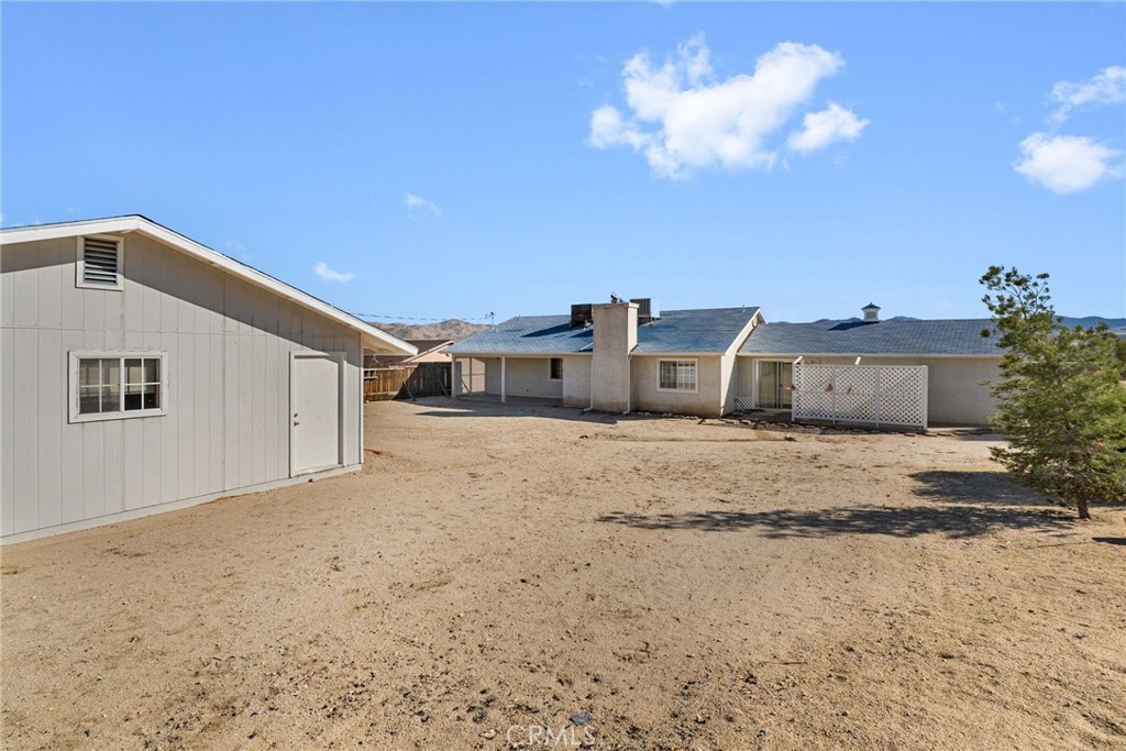 57622 Sierra Way Yucca Valley, CA 92284 - Photo 10 of 75 a view of a house with a snow in the yard