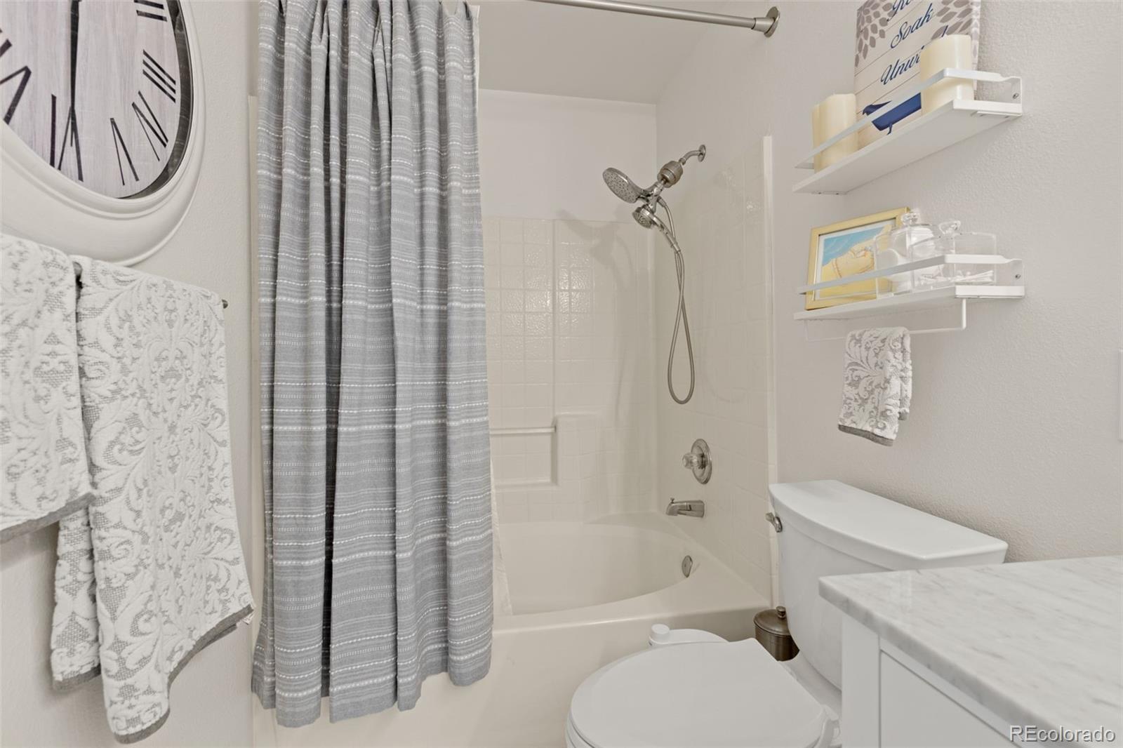 8334 Pebble Creek Way, Unit 201 Highlands Ranch, CO 80126 - Photo 17 of 28 a bathroom with a toilet and a shower