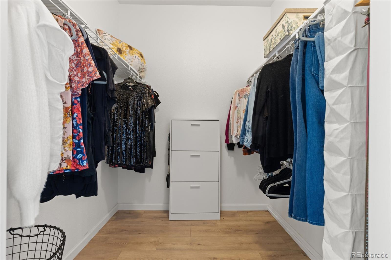 8334 Pebble Creek Way, Unit 201 Highlands Ranch, CO 80126 - Photo 18 of 28 a view of walk in closet with clothes and shoes