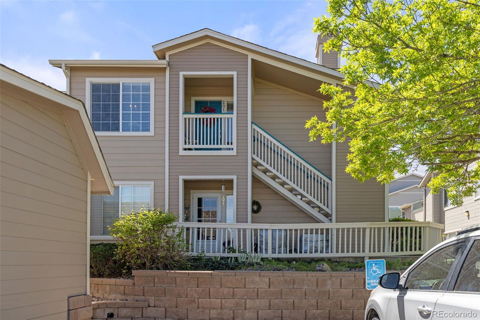 8334 Pebble Creek Way, Unit 201 Highlands Ranch, CO 80126 - Photo 2 of 28 a front view of a house with garden
