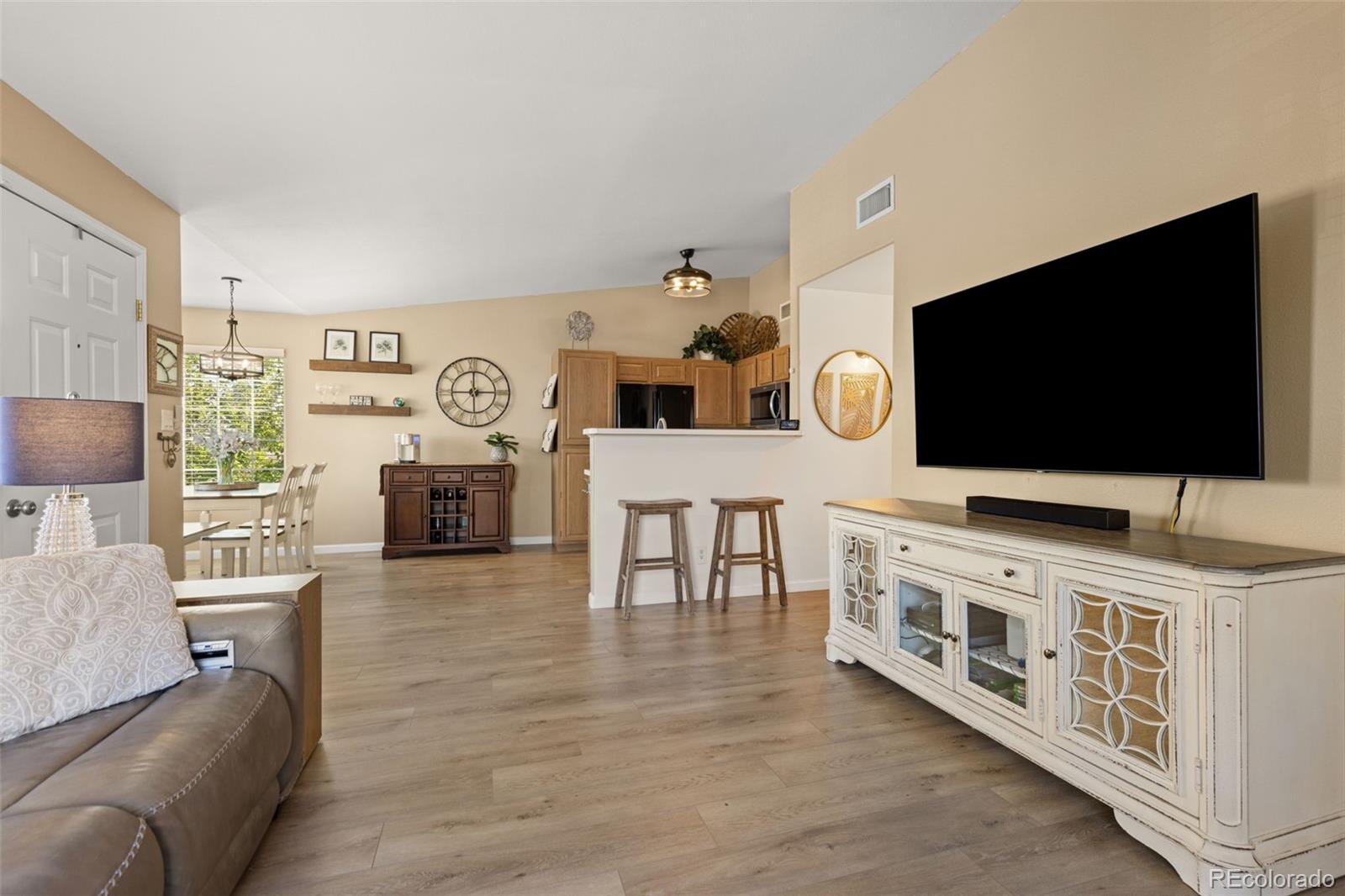 8334 Pebble Creek Way, Unit 201 Highlands Ranch, CO 80126 - Photo 6 of 28 a living room with furniture and a flat screen tv