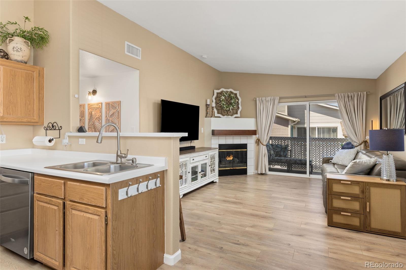 8334 Pebble Creek Way, Unit 201 Highlands Ranch, CO 80126 - Photo 10 of 28 a kitchen with stainless steel appliances granite countertop a sink and a stove top oven