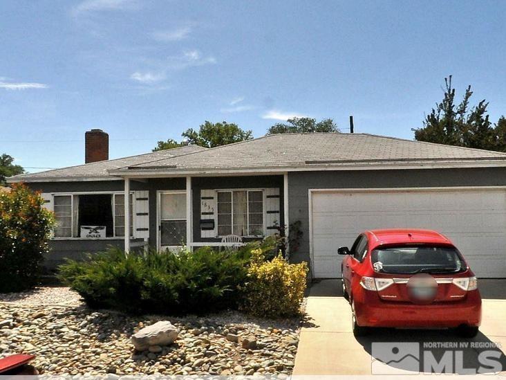 a front view of a house with cars