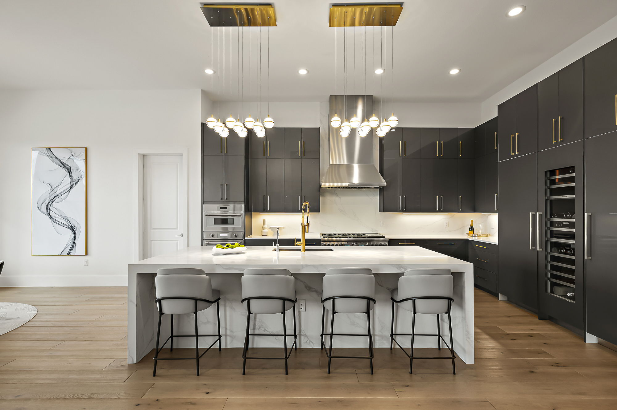 10211 Thistle Ridge Austin, TX 78733 - Photo 15 of 39 Kitchen with a sink, wall chimney exhaust hood, a breakfast bar, light countertops, and recessed lighting