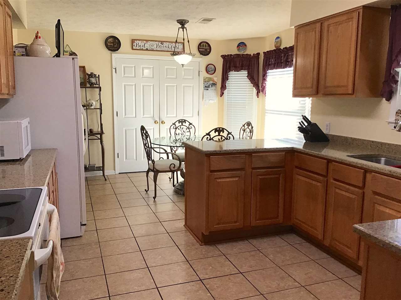 585 Cliffview Road Bolivar, TN 38008 - Photo 13 of 22 a kitchen with stainless steel appliances a sink a stove a refrigerator and cabinets