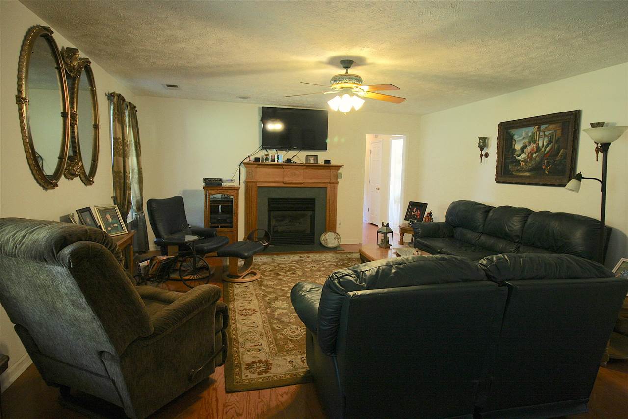 585 Cliffview Road Bolivar, TN 38008 - Photo 4 of 22 a living room with furniture a fireplace and a flat screen tv