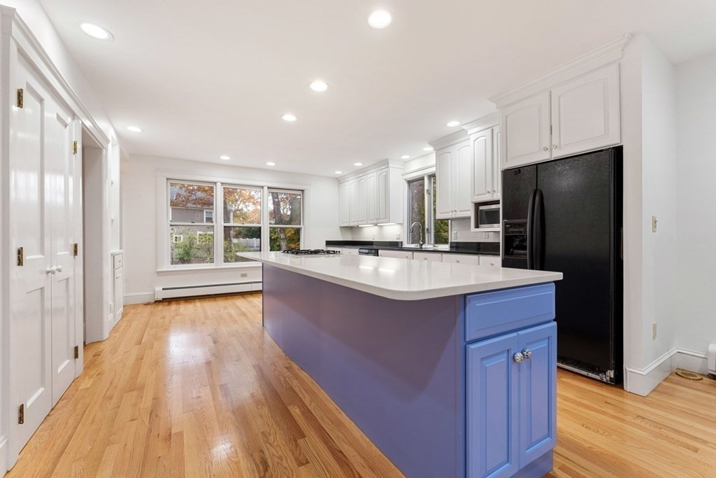 575 Chestnut Street Newton, MA 02468 - Photo 12 of 30 a kitchen with stainless steel appliances granite countertop a sink stove and refrigerator