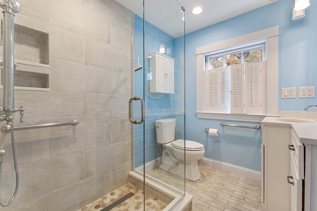 575 Chestnut Street Newton, MA 02468 - Photo 19 of 30 a bathroom with a granite countertop bathtub a toilet and a shower