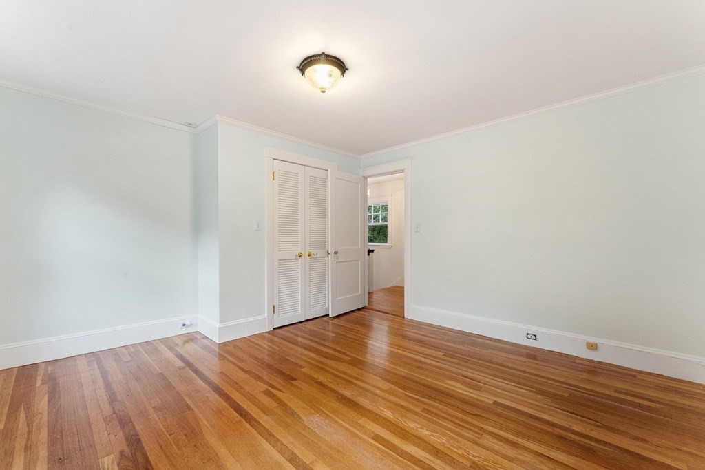575 Chestnut Street Newton, MA 02468 - Photo 21 of 30 a view of room with wooden floor and white walls