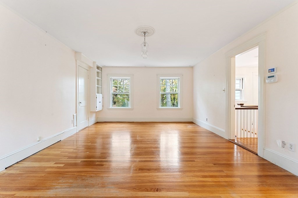 575 Chestnut Street Newton, MA 02468 - Photo 22 of 30 a view of an empty room with wooden floor and a window