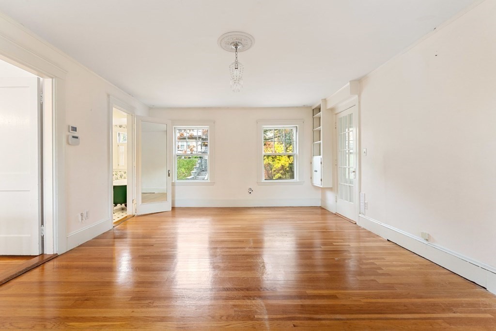 575 Chestnut Street Newton, MA 02468 - Photo 23 of 30 a view of an empty room with window and wooden floor