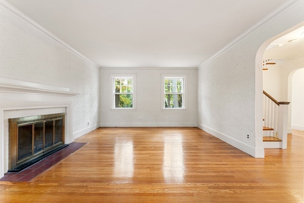 575 Chestnut Street Newton, MA 02468 - Photo 5 of 30 a view of an empty room with wooden floor fireplace and a window