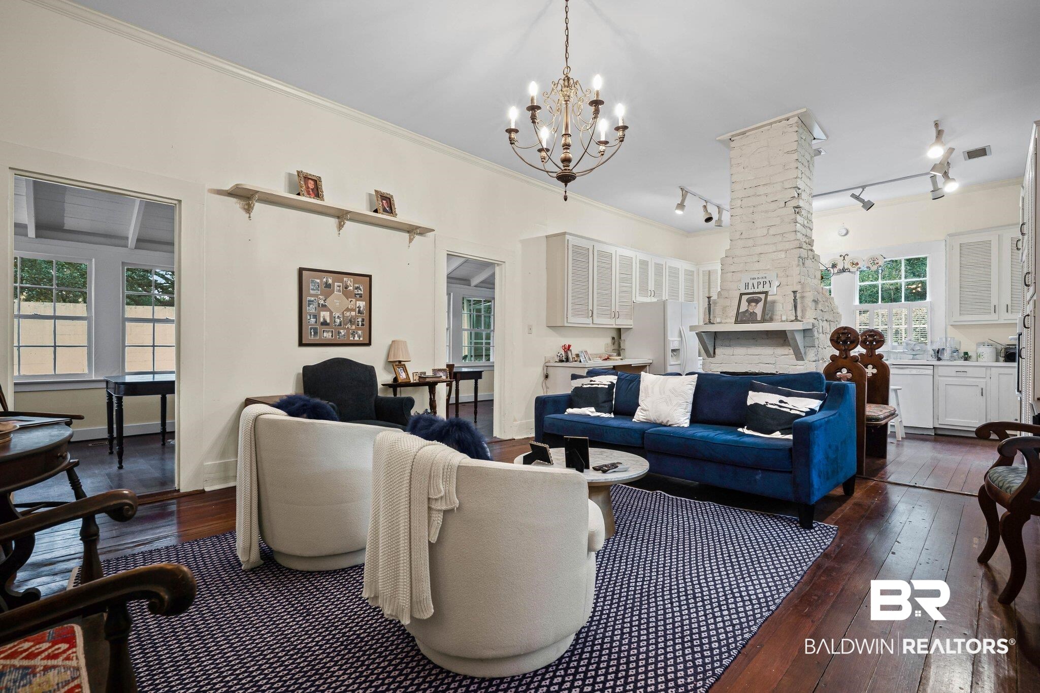 23561 Main Street Fairhope, AL 36532 - Photo 9 of 45 Living room featuring dark wood-style flooring, track lighting, a chandelier, and ornamental molding