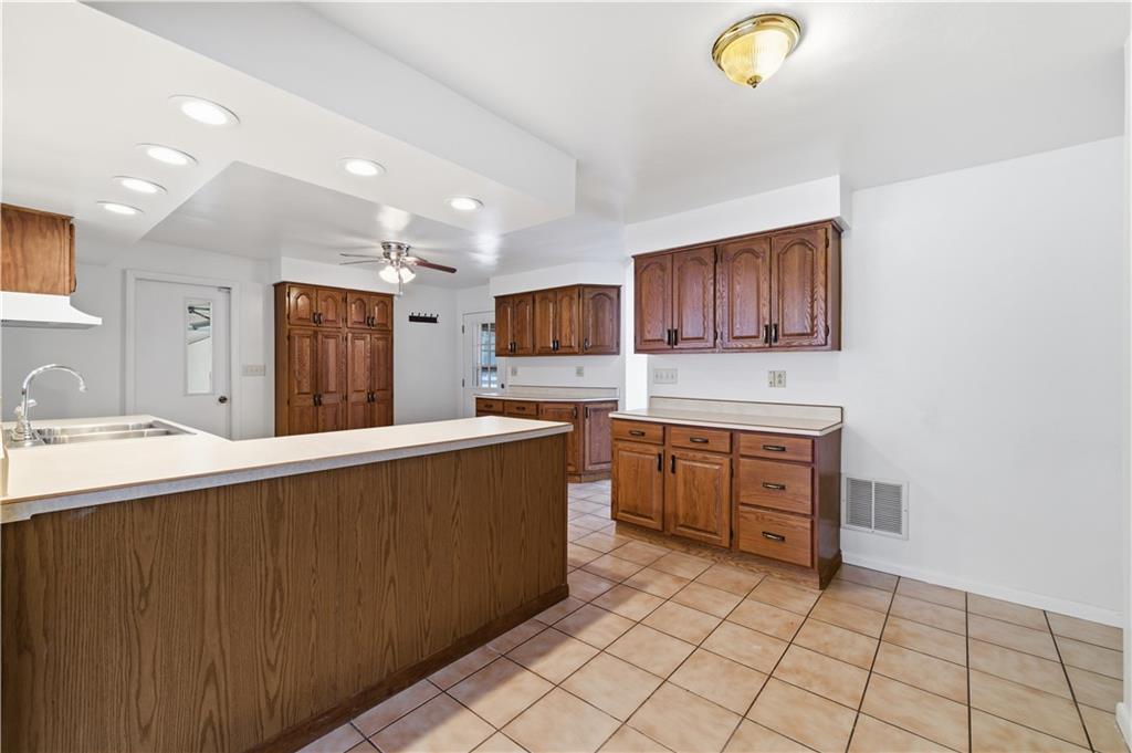2161 Bull Creek Road Tarentum, PA 15084 - Photo 16 of 32 a kitchen with stainless steel appliances a sink stove and cabinets