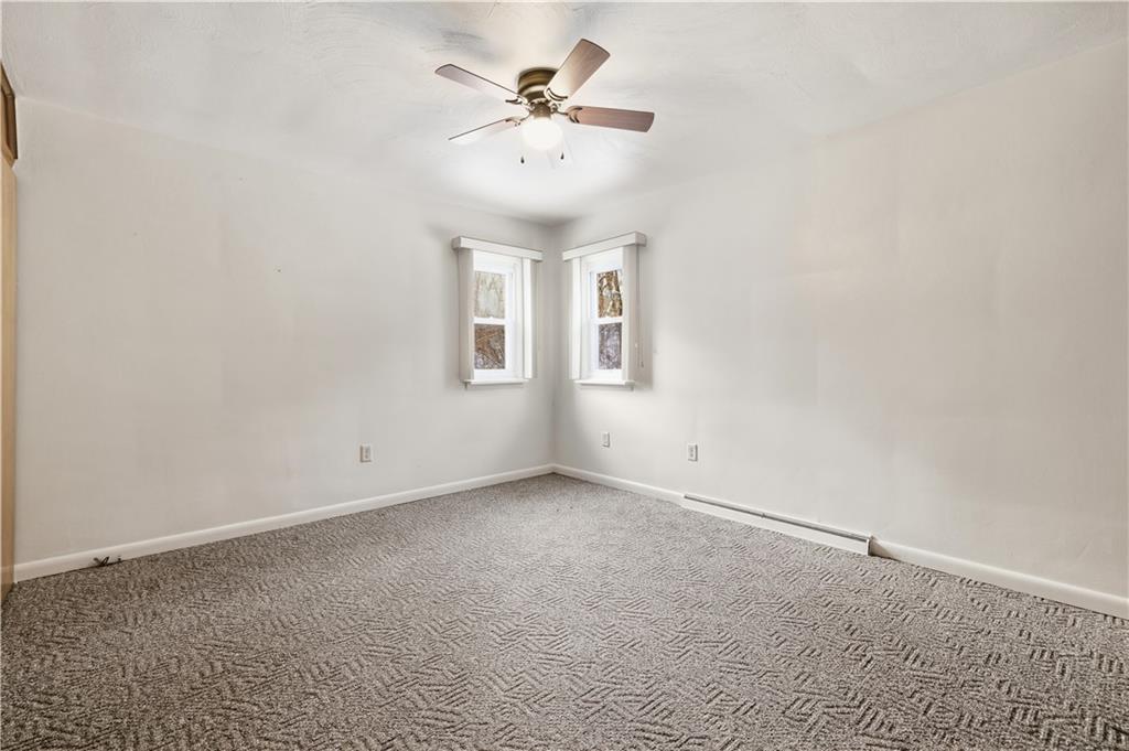 2161 Bull Creek Road Tarentum, PA 15084 - Photo 26 of 32 an empty room with windows and chandelier fan