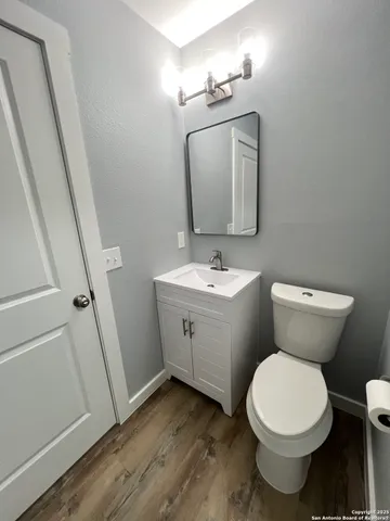 a bathroom with a toilet sink and mirror