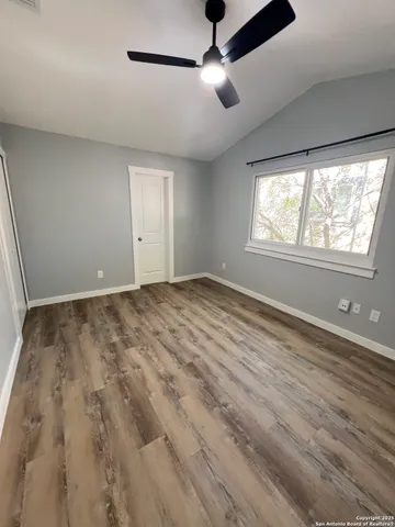 a view of room with window and ceiling fan