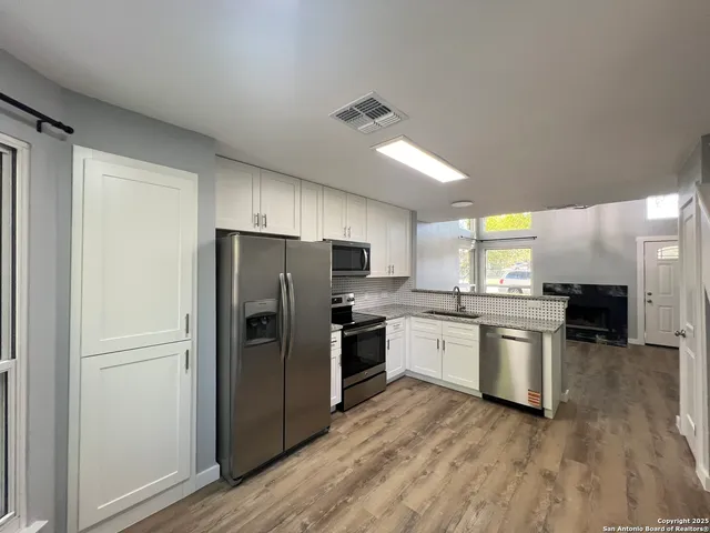 a kitchen with a refrigerator and a sink
