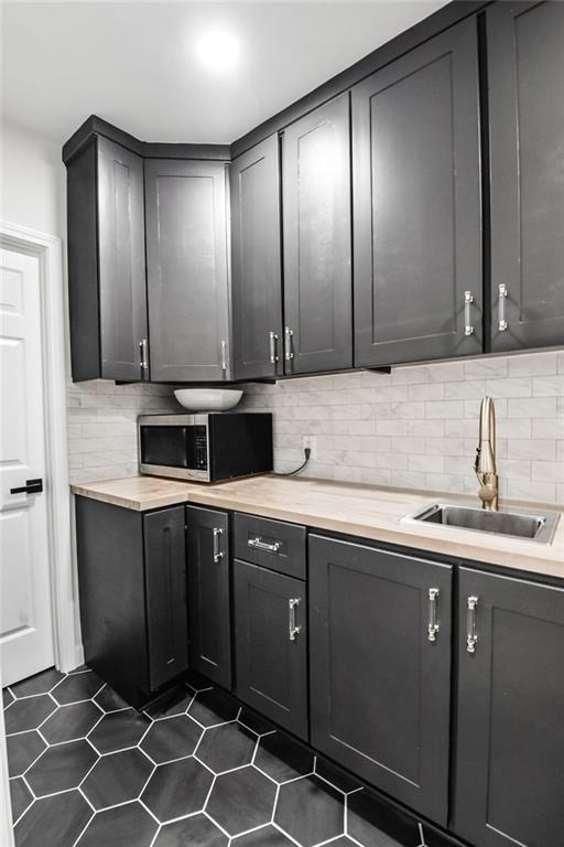 150 Sims Street Winder, GA 30680 - Photo 20 of 61 a kitchen with a sink and cabinets