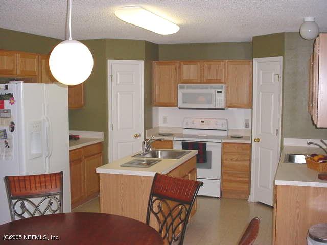 55365 Little Brook Drive Callahan, FL 32011 - Photo 5 of 9 a kitchen with a sink cabinets and wooden floor
