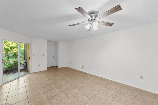 a view of a livingroom with a ceiling fan and window