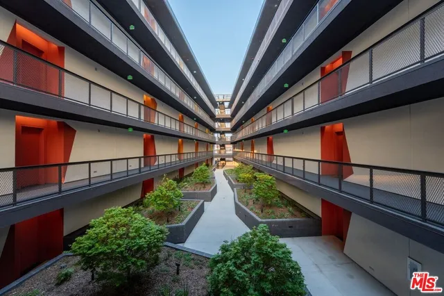 a view of a house with large windows and a small yard