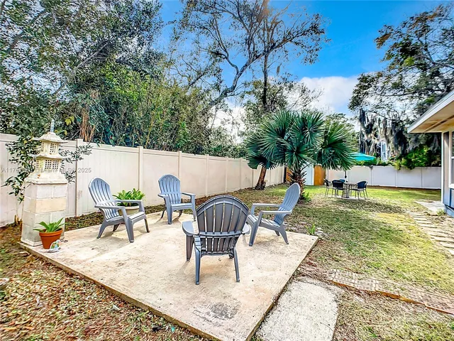 a view of a house with pool and a yard