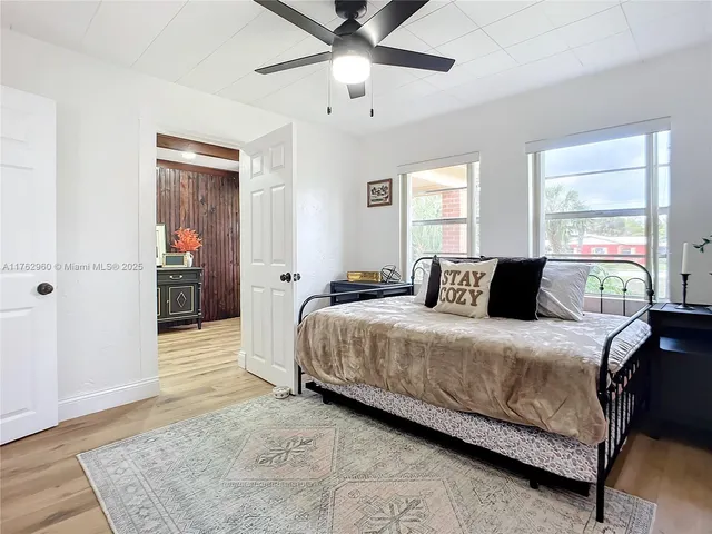 a bedroom with two beds and a chandelier