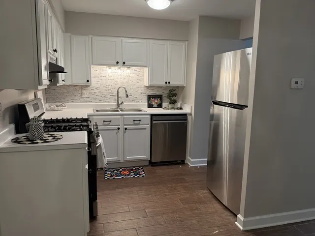 a kitchen with a stove refrigerator and cabinets