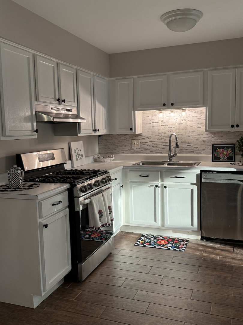19380 Wolf Road, Unit 5 Mokena, IL 60448 - Photo 7 of 20 a kitchen with kitchen island granite countertop a sink cabinets and stainless steel appliances