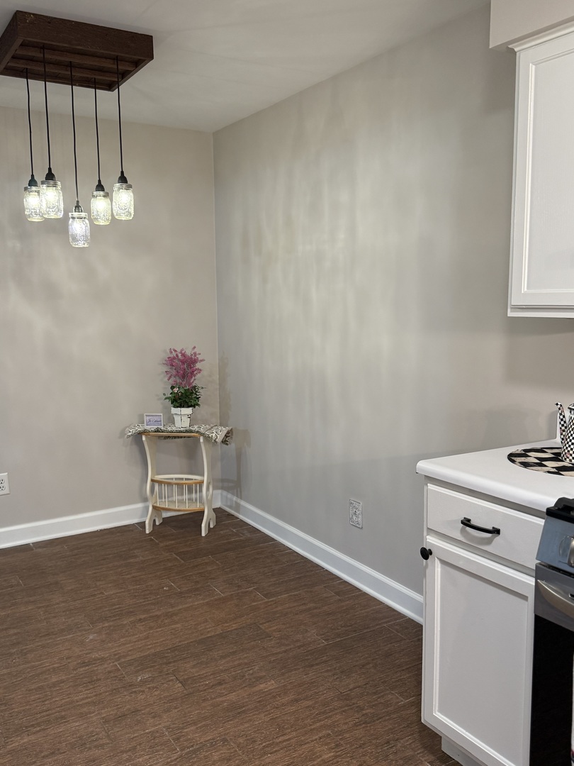 19380 Wolf Road, Unit 5 Mokena, IL 60448 - Photo 10 of 20 a view of dining room and kitchen with a sink wooden cabinets and table