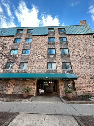 an empty room with wooden floor and fireplace