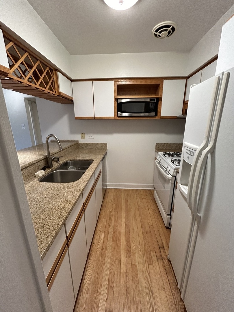 401 West Webster Avenue, Unit 502 Chicago, IL 60614 - Photo 4 of 9 a kitchen with sink and refrigerator