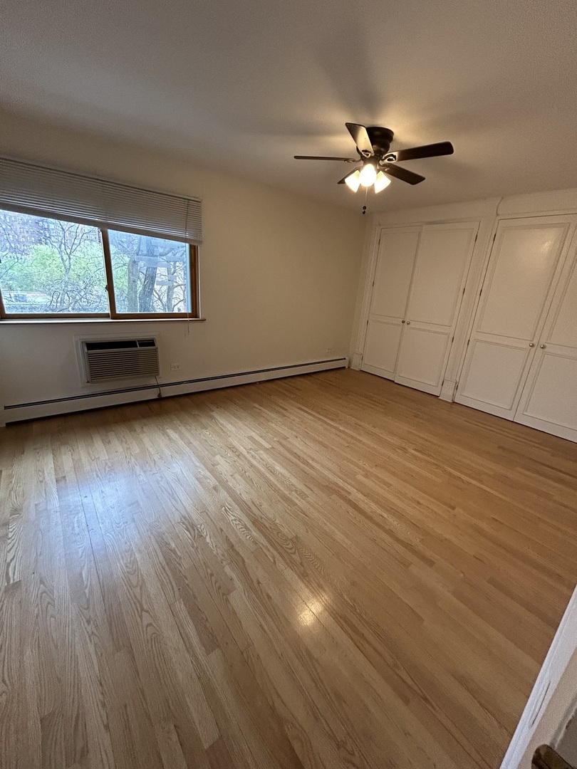 401 West Webster Avenue, Unit 502 Chicago, IL 60614 - Photo 5 of 9 a view of an empty room with wooden floor and a window