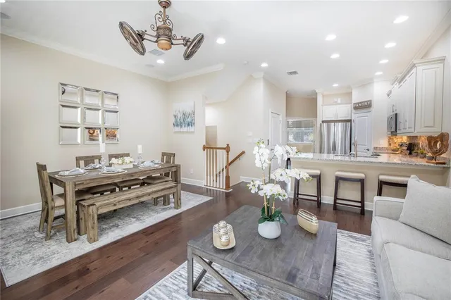 a kitchen with granite countertop white cabinets and stainless steel appliances