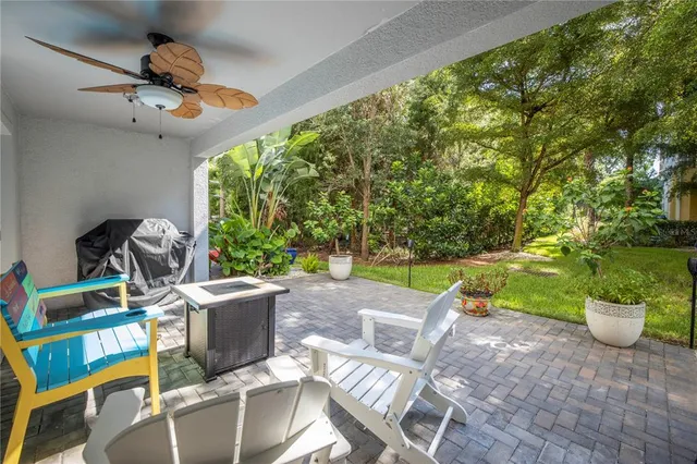 a kitchen with stainless steel appliances lots of counter top space and furniture