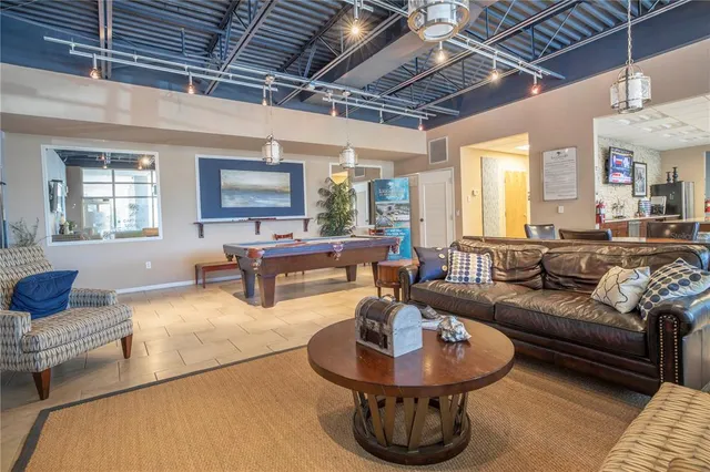 a large kitchen with stainless steel appliances lots of counter space and a sink