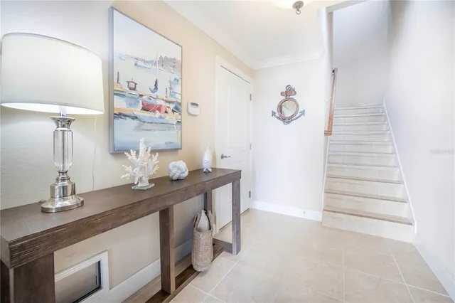 a view of a hallway with wooden floor and a living room