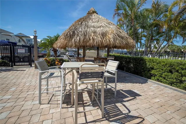 a view of a house with a yard and potted plants