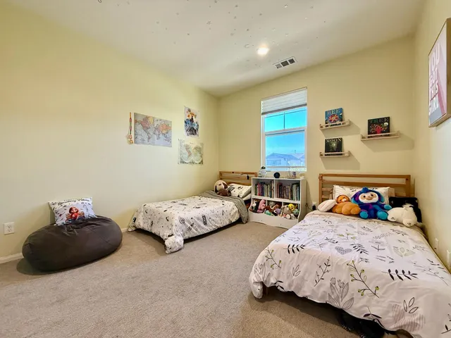 a bedroom with two beds and a couch