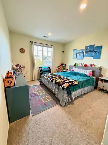 a bed sitting in a bedroom next to a window