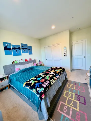 a bed sitting in a bedroom next to a window