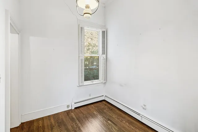 an empty room with windows and chandelier