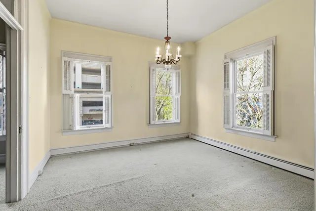 a view of a house with backyard and wooden fence