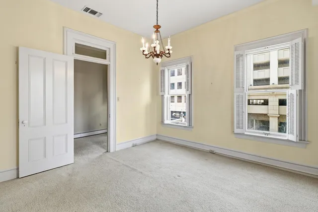 a view of a house with a window and wooden fence